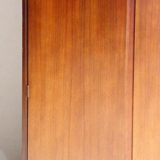 Vintage mid-century teak wardrobe by William Laurence with smooth wood grain and sleek British-Denmark design.
