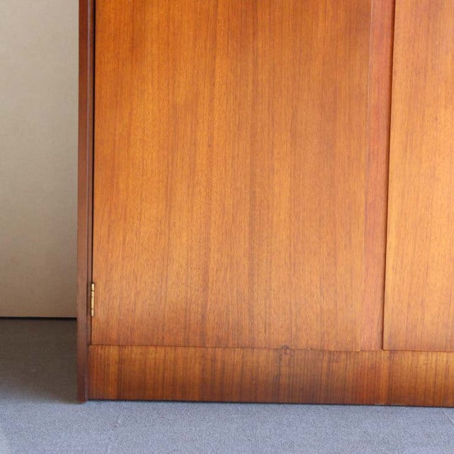 Vintage teak cabinet door with rich wood grain and warm British mid-century design from William Laurence.
