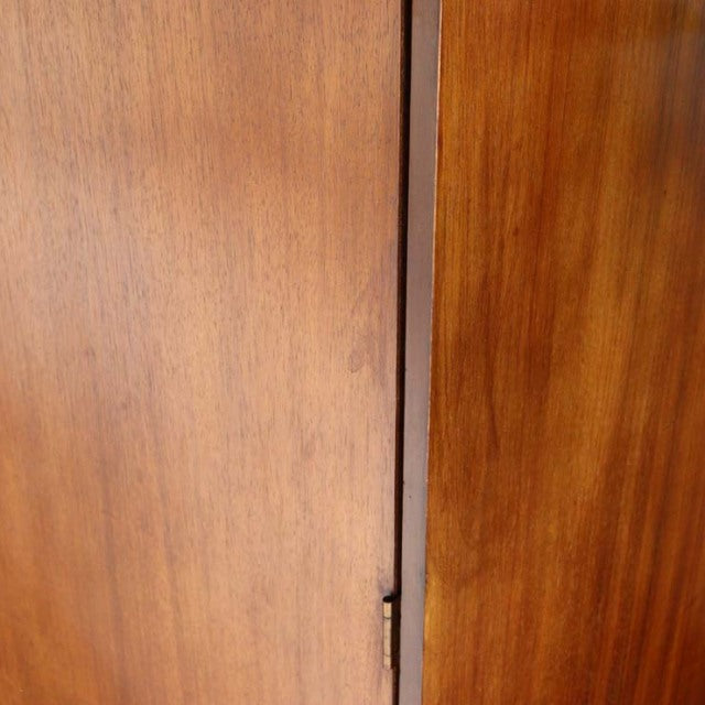 Close-up of vintage British mid-century teak cabinet door showing smooth wood grain and warm honey tones from William.