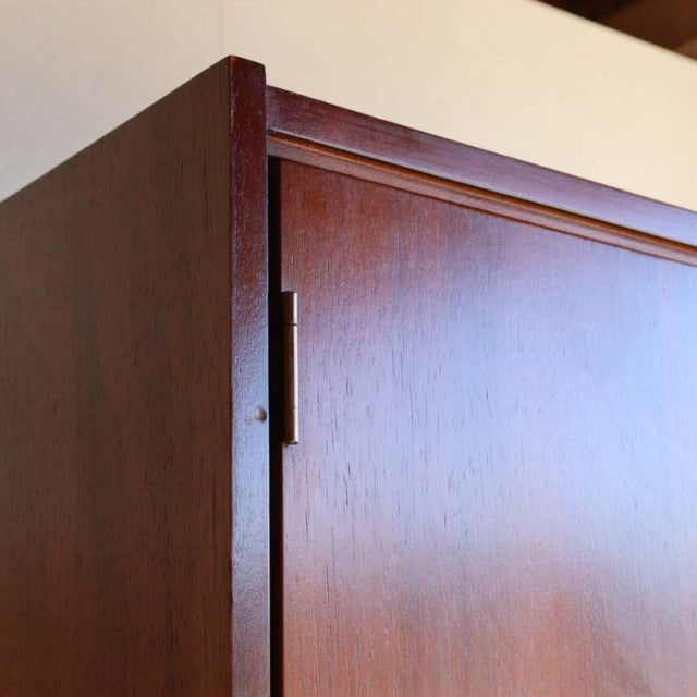 Vintage British mid-century teak cabinet by William Laurence with clean grain and minimalist handle detail.