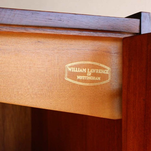 Close-up of vintage teak wood drawer interior with William Laurence Nottingham brass label, mid-century British.