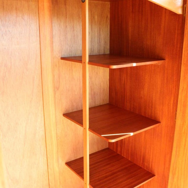 Vintage mid-century teak shelving unit by William Laurence with rich wood grain and sleek vertical supports, British-Denmark .
