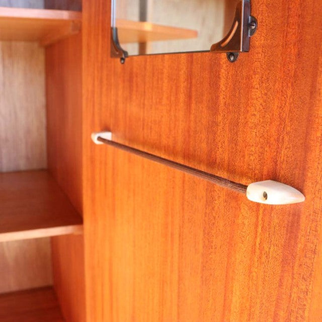 Vintage mid-century teak cabinet interior with visible wood grain and metal hanging rod, British-Denmark design by William.