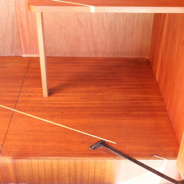 Vintage teak mid-century cabinet interior from British brand William Laurence with smooth wood grain and clean lines.
