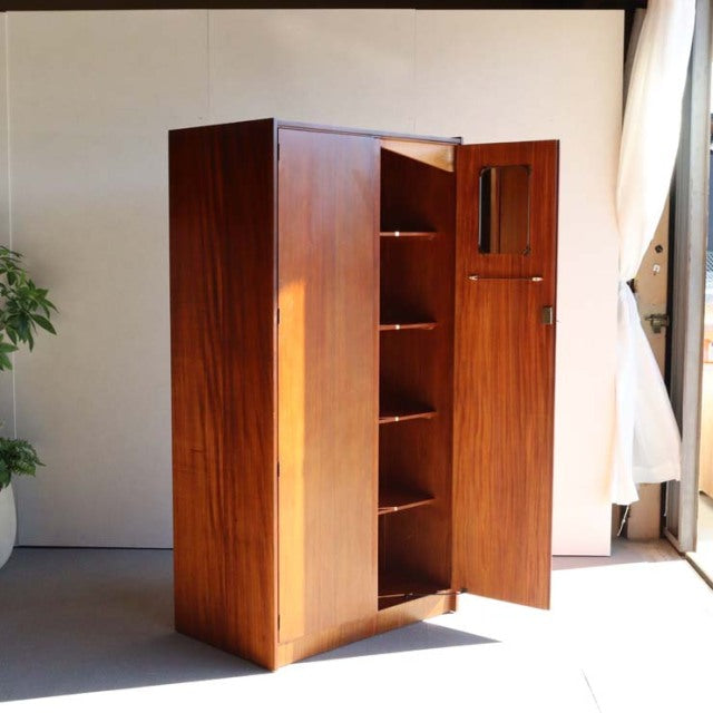 Vintage mid-century teak wardrobe by William Laurence with rich wood grain, slender legs, and upright rectangular form,.