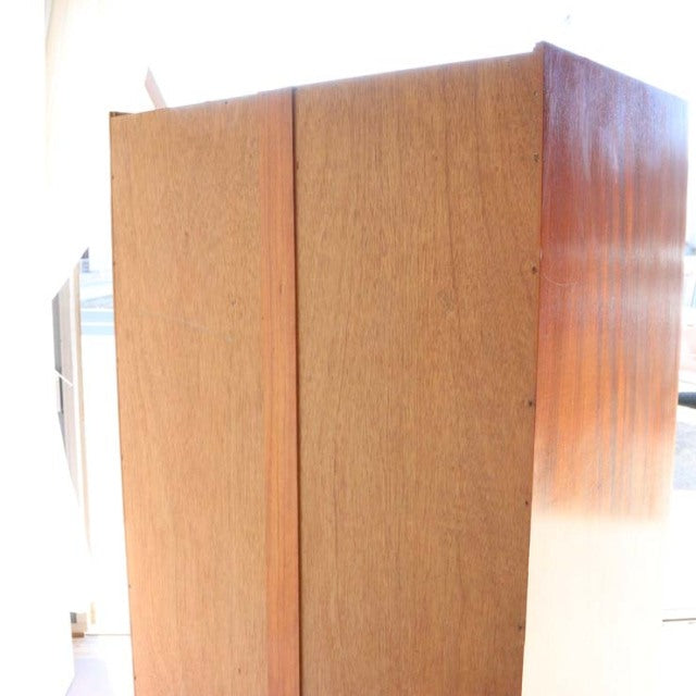 Vintage mid-century teak wardrobe by William Laurence with clean British-Denmark design, smooth wood grain, and slender legs.