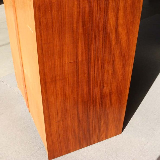 Vintage teak cabinet side panel showcasing rich British mid-century wood grain with clean lines and smooth finish.