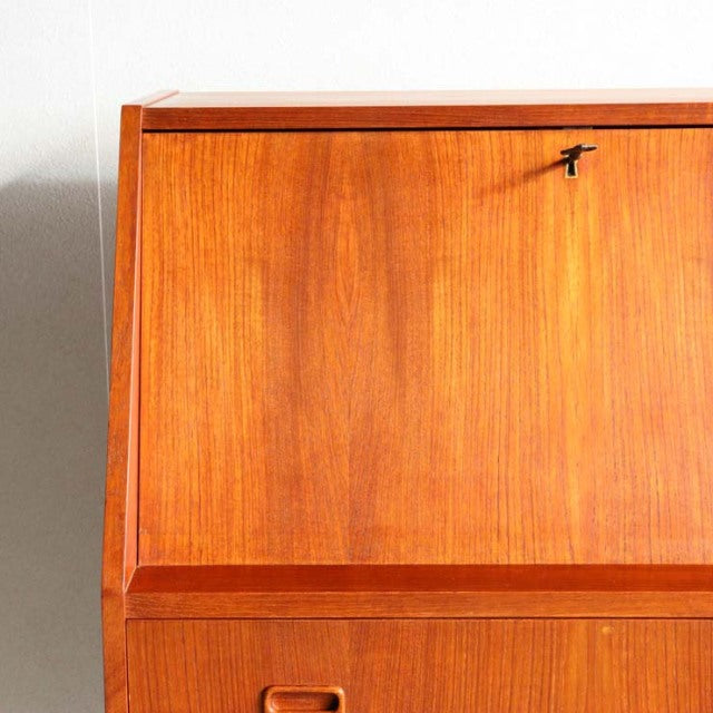 Vintage teak mid-century bureau by Gunnar Nielsen Tibergaard, Danish design with smooth wood grain and brass keyhole detail.