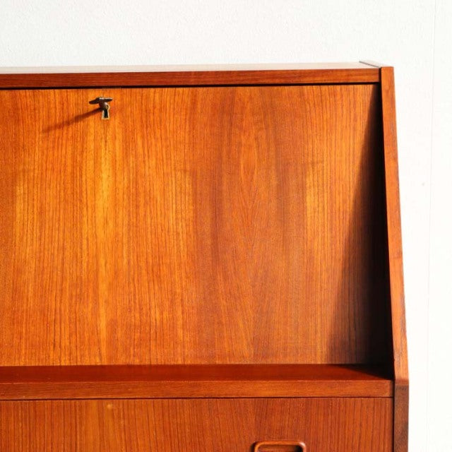 Vintage Danish teak bureau by Gunnar Nielsen Tibergaard with rich wood grain, clean mid-century lines, and sleek.