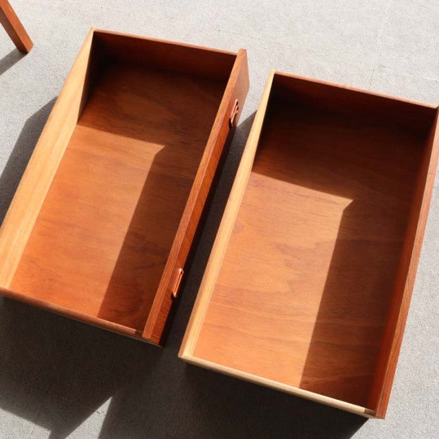 Pair of teak drawers with rich wood grain, clean lines, and mid-century Danish design features.