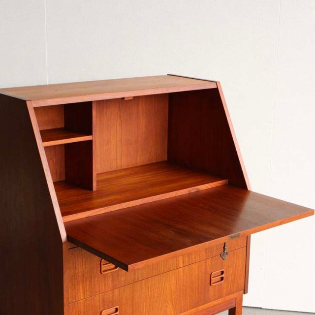 Mid-century vintage Danish teak bureau by Gunnar Nielsen Tibergaard with rich wood grain, angled sides, and slender tapered.