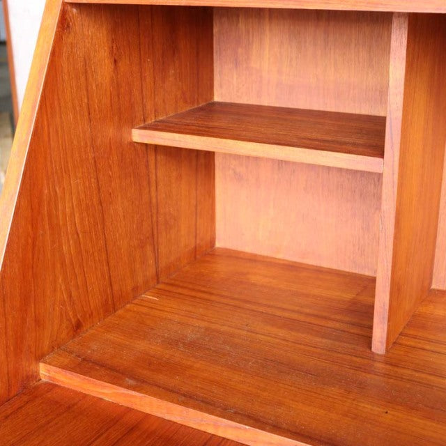 Vintage teak wood bureau interior from mid-century Denmark, showcasing rich wood grain and clean lines.