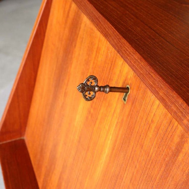 Vintage mid-century teak bureau door corner with rich wood grain and ornate brass key by Gunnar Nielsen Tibergaard, Denmark.