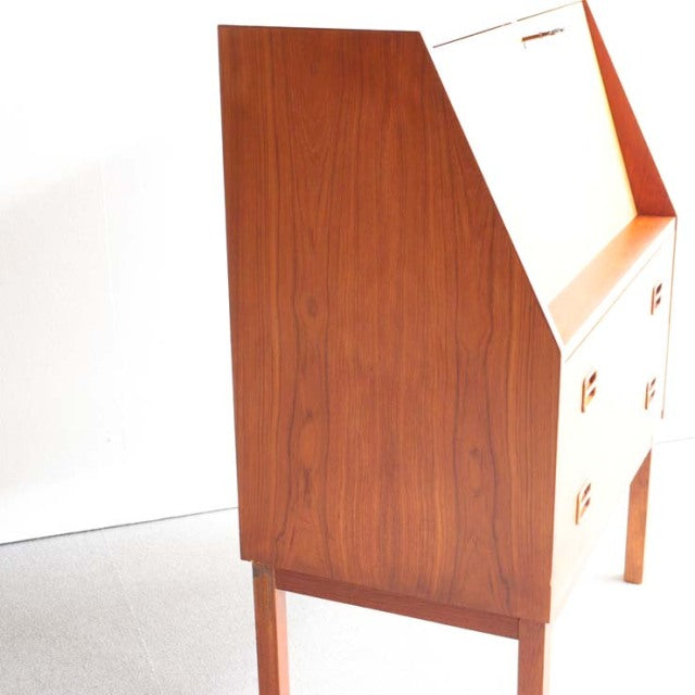 Vintage teak bureau by Gunnar Nielsen Tibergaard, mid-century Denmark, showing smooth wood grain and tapered legs.
