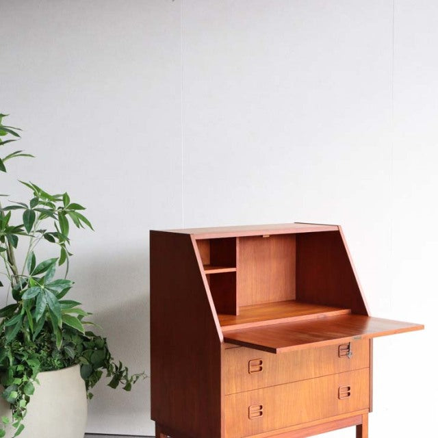 Vintage mid-century Danish teak bureau by Gunnar Nielsen Tibergaard with clean lines, angled top, and storage drawers.