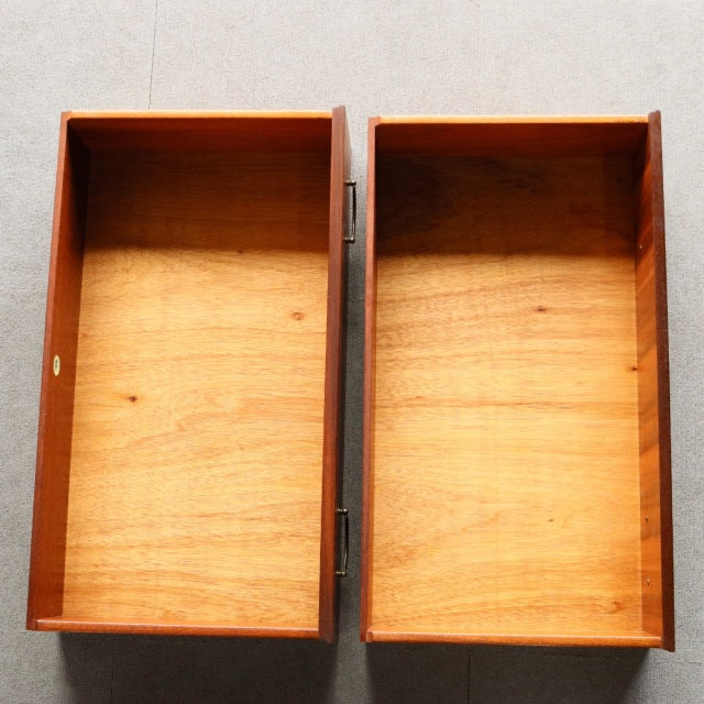 Open drawers of vintage mid-century teak chest by Meredew, showcasing warm wood grain and smooth interior craftsmanship.