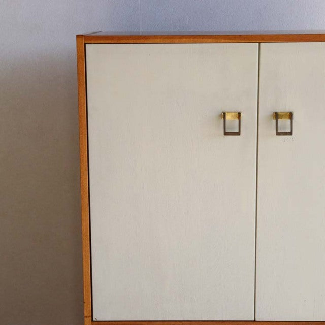 Mid-century British vintage teak cabinet by G-PLAN with clean lines, cream doors, and square brass handles.