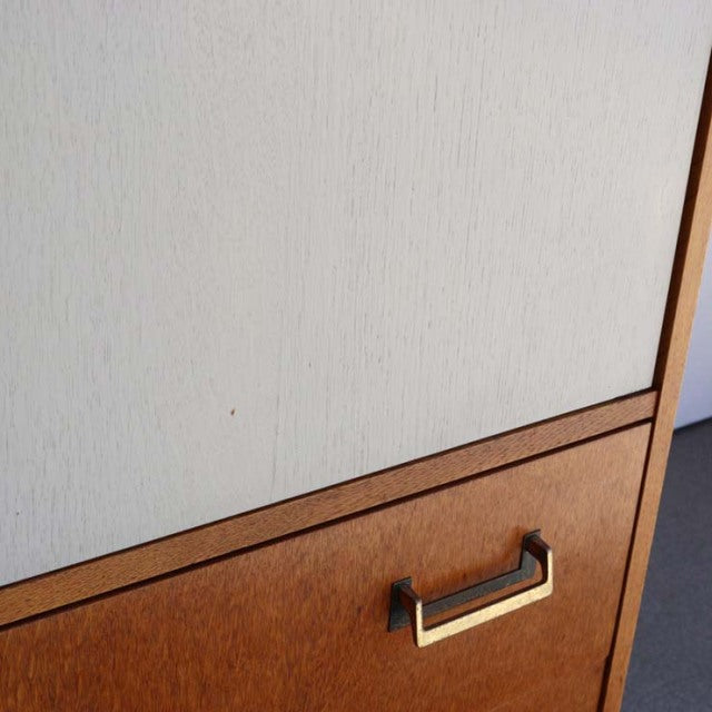 Vintage British mid-century G-Plan oak cabinet with warm wood grain and brass handle detail.