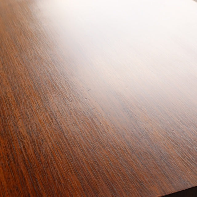 Close-up of vintage teak wood grain surface from British mid-century Meredew 5-drawer chest, smooth finish with warm tones.