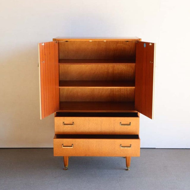 Vintage British G-PLAN mid-century teak tallboy cabinet with open doors, wood grain, and tapered legs.