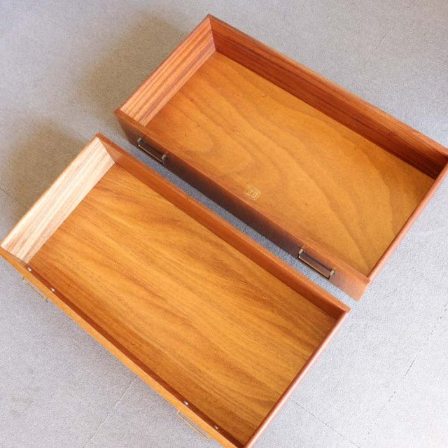 Open teak drawers of British mid-century G-Plan vintage oak cabinet with visible wood grain and smooth edges.