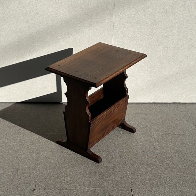 Vintage British teak mid-century side table with rich wood grain, sculpted sides, and flat top surface.