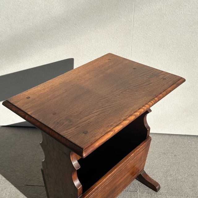 Vintage British teak mid-century small antique table with rich wood grain and curved side panels.