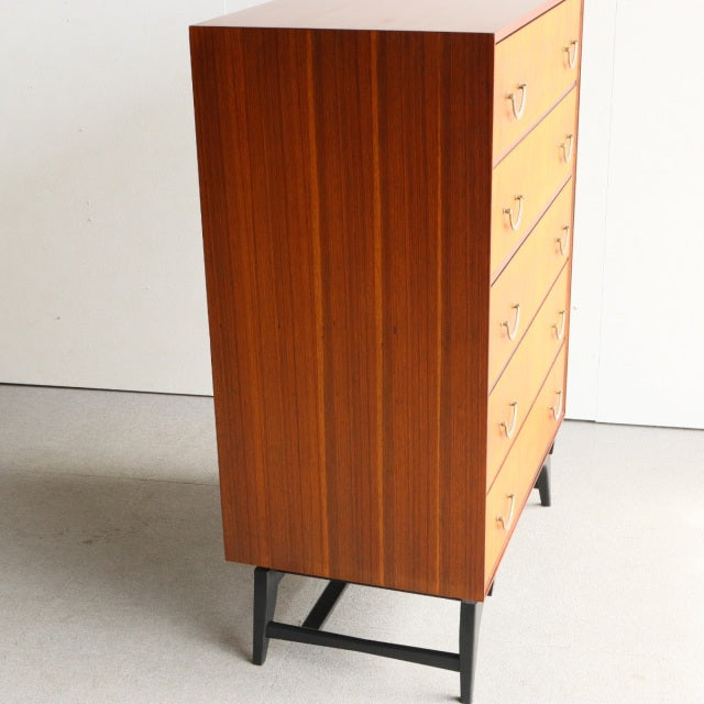 Mid-century British teak 5-drawer chest by Meredew with rich wood grain and black metal legs.