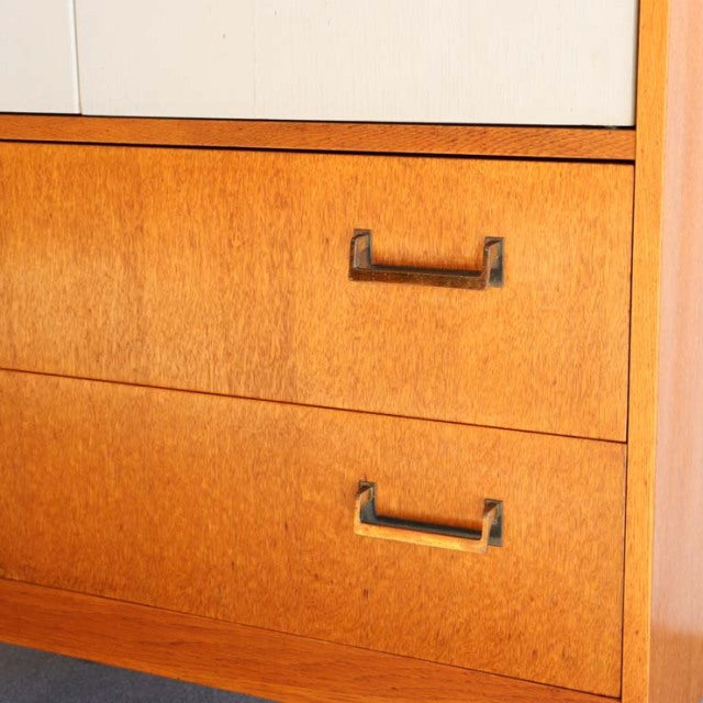Vintage mid-century British G-Plan teak cabinet drawers with wood grain and metal handles.