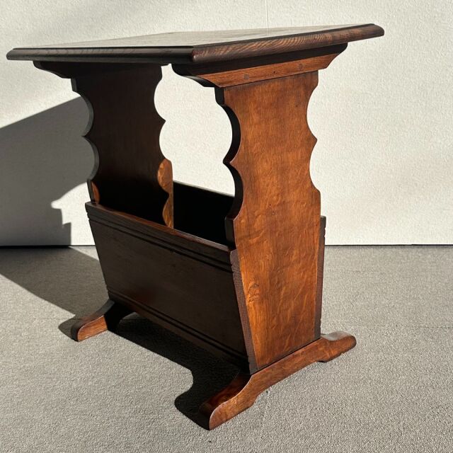 Mid-century British vintage teak side table with scalloped carved legs and rich wood grain.