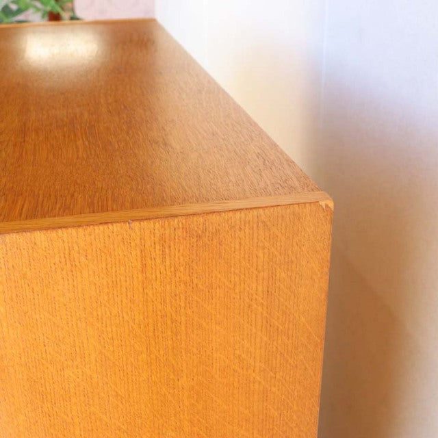 Vintage mid-century teak G-PLAN cabinet corner showcasing rich wood grain and smooth, clean edges.