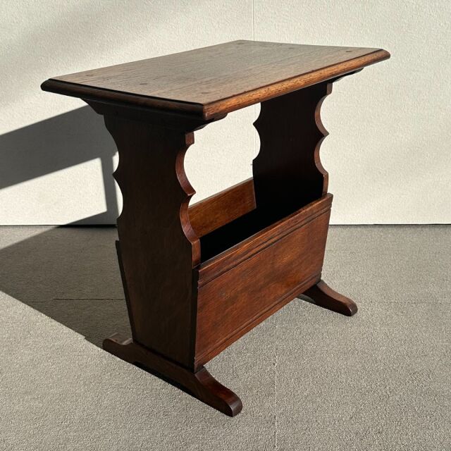 Vintage teak mid-century British side table with curved supports and visible wood grain.