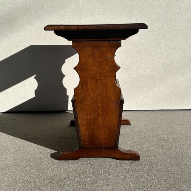 Mid-century British teak vintage side table with rich wood grain and sculpted central pedestal base from Denmark.