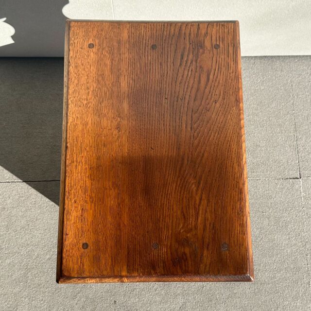 Vintage British mid-century teak table top showing rich wood grain and rounded edges.