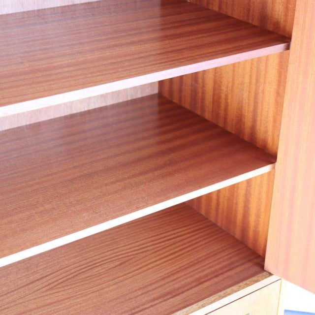 Vintage British mid-century teak G-Plan cabinet shelves with warm wood grain and clean lines.