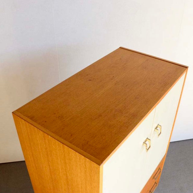 Vintage G-Plan teak mid-century tallboy cabinet with clean wood grain and brass handles.