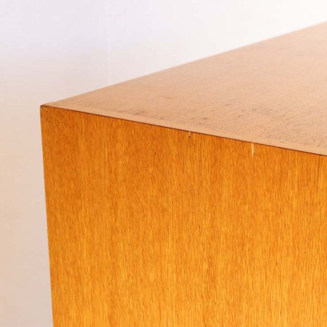 Close-up of vintage British mid-century G-PLAN teak cabinet corner showing smooth wood grain and sharp edges.