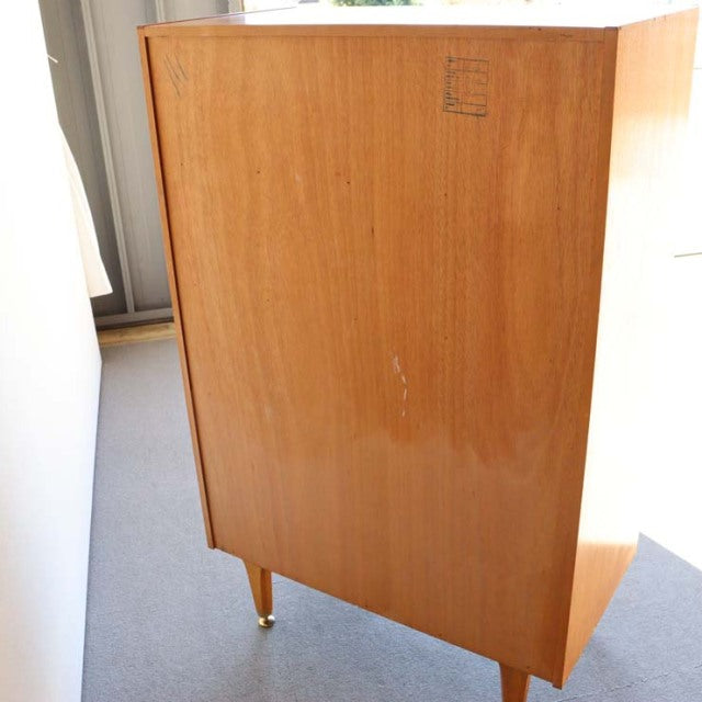 Vintage G-Plan teak cabinet with mid-century British design, tapered legs, and smooth wood grain.