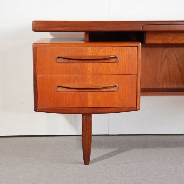 Mid-century British G-PLAN teak desk drawer with curved wood handles and tapered leg, vintage Danish style.