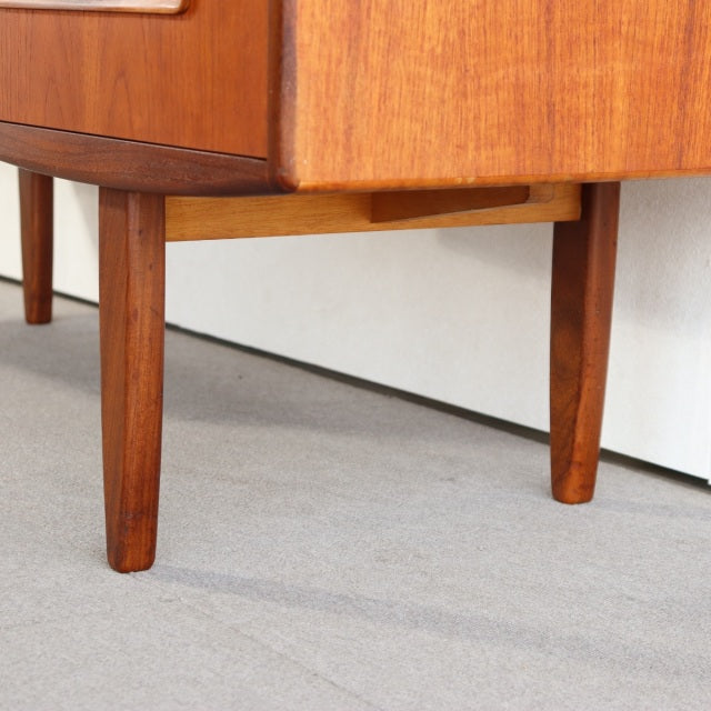 Mid-century British G-PLAN teak desk legs with smooth wood grain and tapered design.