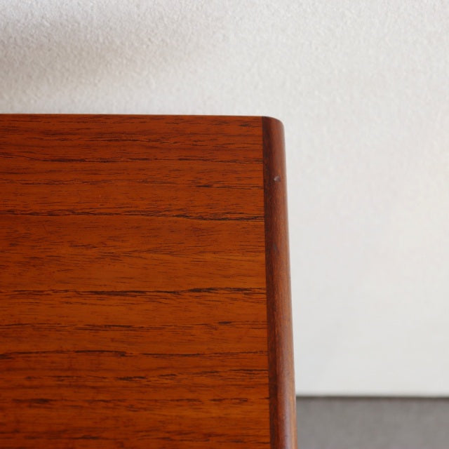 Vintage mid-century British G-PLAN teak desk corner showing rich wood grain and rounded edge.