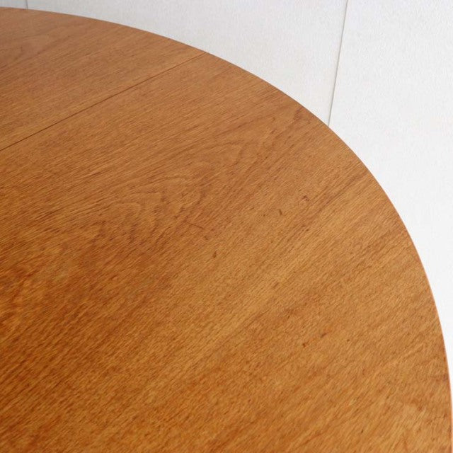 Round vintage teak dining table top with fine wood grain, mid-century British design.
