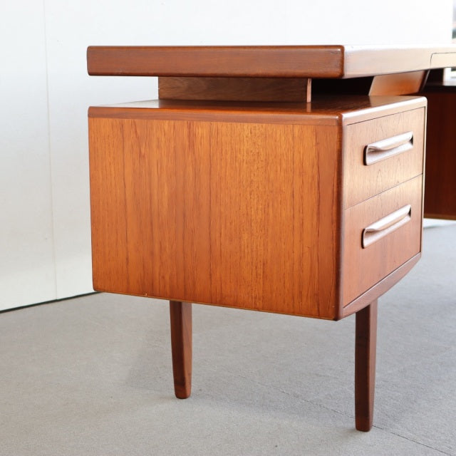 Vintage British G-PLAN teak desk with rich wood grain, tapered legs, and mid-century Danish design features.