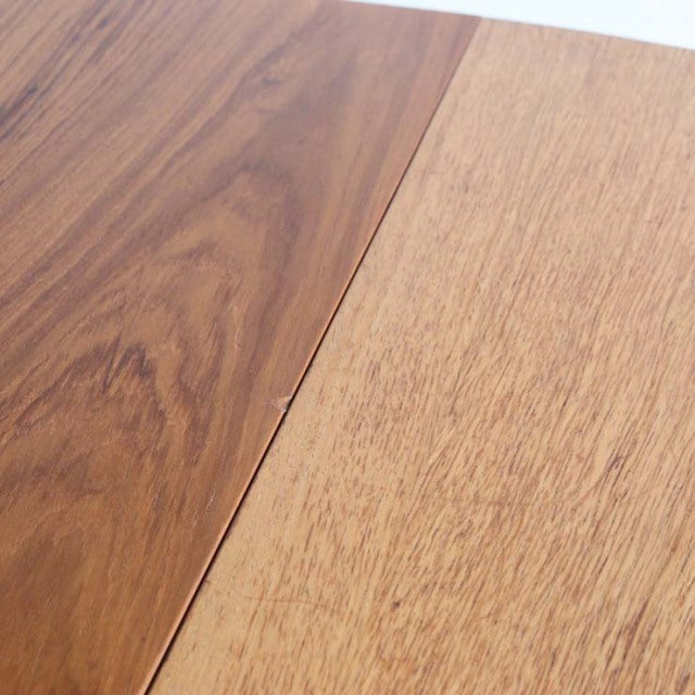 Close-up of vintage teak dining table top showing rich wood grain and seamless joint detail from British mid-century Danish.