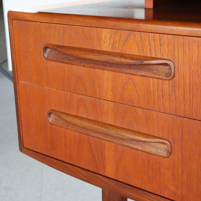 Vintage teak G-PLAN mid-century British desk drawers with sculpted wooden handles and rich wood grain detailing.