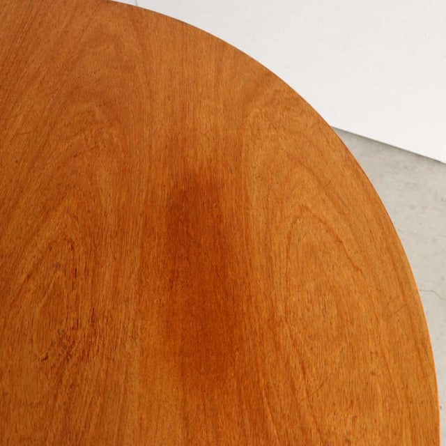 Round vintage teak dining table top with smooth wood grain, mid-century British design.