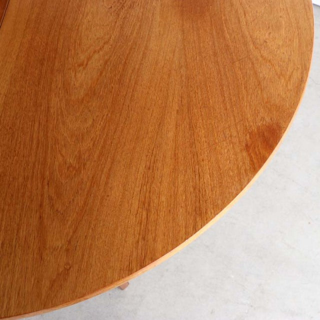 Round vintage teak dining table top with rich wood grain, British mid-century style from Denmark.