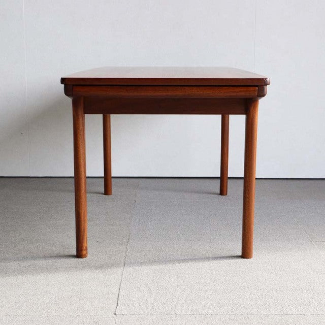 Vintage mid-century McIntosh teak coffee table from Britain with clean lines, rounded legs, and rich wood grain visible on.