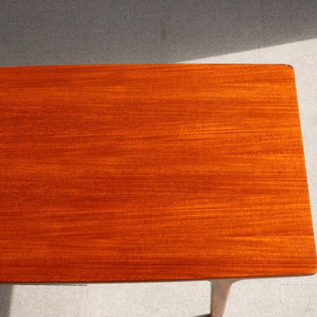 Mid-century British teak coffee table by McIntosh with smooth grain and rounded edges, Denmark design influence visible in.