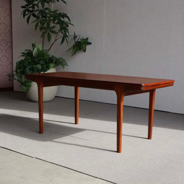 Mid-century British McIntosh teak coffee table with straight legs and visible wood grain.